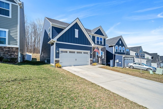 view of front of property with concrete driveway, stone siding, an attached garage, a front lawn, and board and batten siding