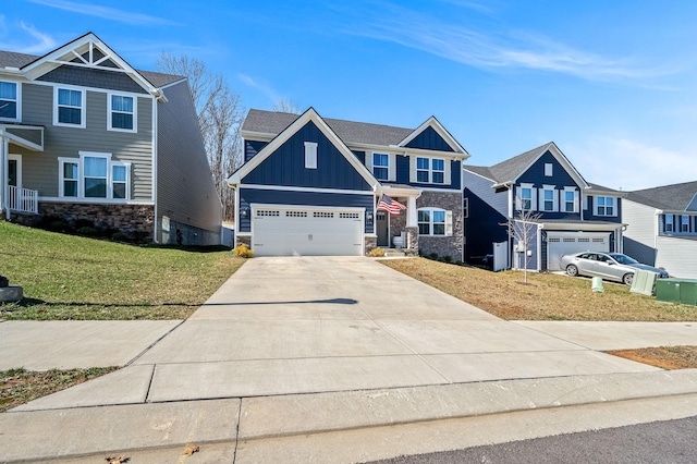 craftsman inspired home featuring concrete driveway, board and batten siding, a garage, stone siding, and a front lawn