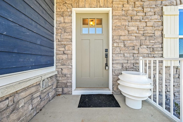 doorway to property featuring stone siding