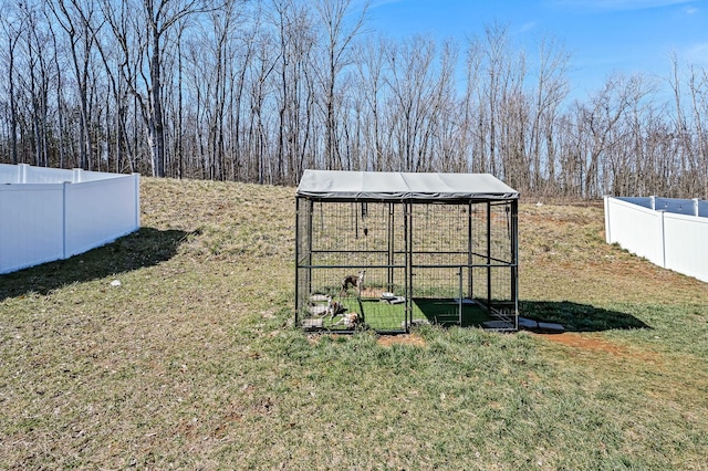 view of yard featuring fence and an outdoor structure