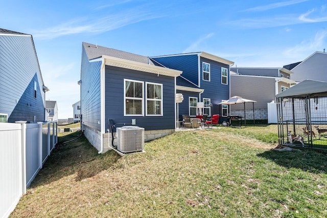 back of house with a patio, fence, a lawn, and central AC unit