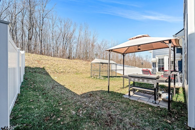 view of yard featuring a gazebo, a patio, and a fenced backyard