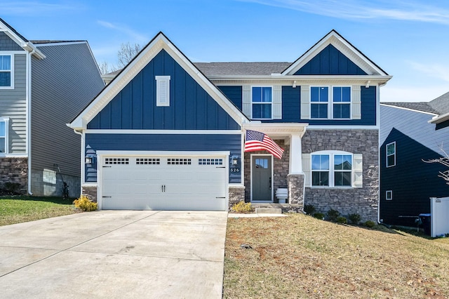 craftsman-style house with an attached garage, driveway, stone siding, a front lawn, and board and batten siding