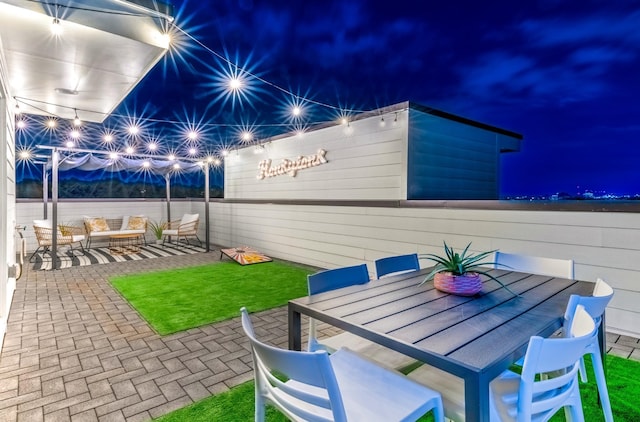 patio at twilight featuring outdoor dining space