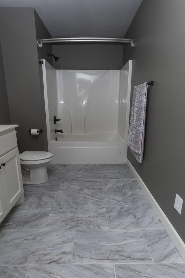 full bath with baseboards, toilet, marble finish floor, tub / shower combination, and vanity