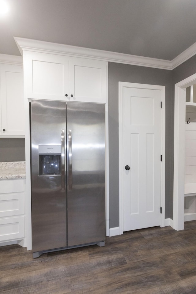 kitchen featuring dark wood-style flooring, white cabinetry, stainless steel fridge with ice dispenser, light stone countertops, and crown molding