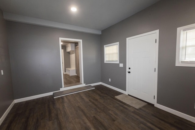 foyer entrance with dark wood-type flooring, recessed lighting, and baseboards