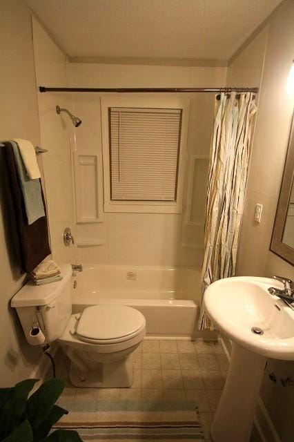 full bathroom featuring shower / tub combo and toilet