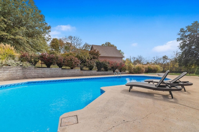 view of pool featuring a patio area, fence, and a fenced in pool