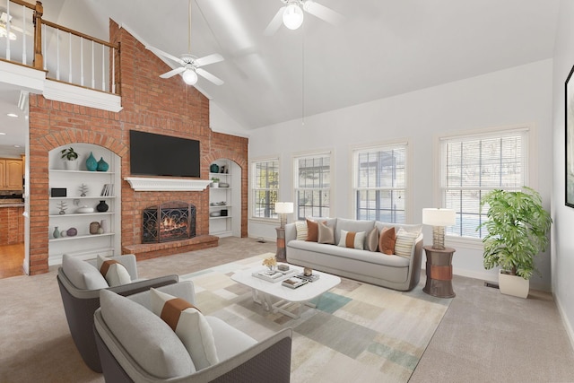 carpeted living area featuring baseboards, a ceiling fan, a brick fireplace, built in shelves, and high vaulted ceiling