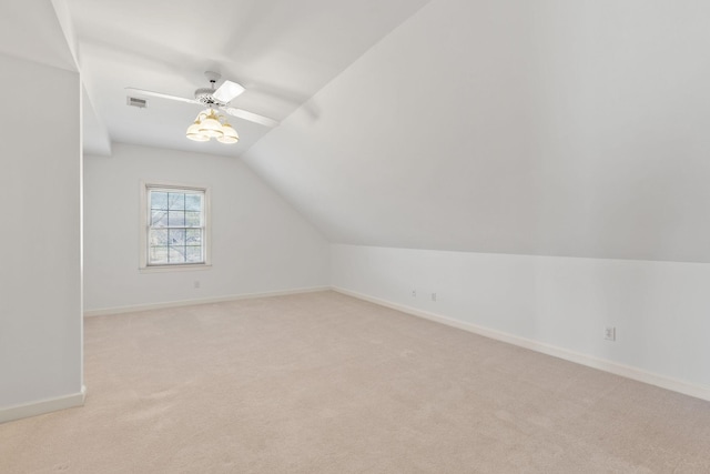 bonus room with light carpet, baseboards, visible vents, ceiling fan, and vaulted ceiling