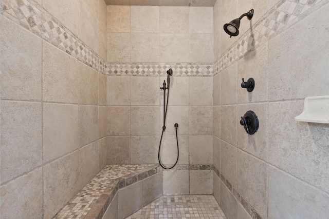 bathroom with a tile shower