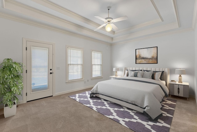 bedroom featuring baseboards, a raised ceiling, a ceiling fan, crown molding, and carpet floors