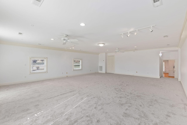 spare room featuring ceiling fan, visible vents, and crown molding