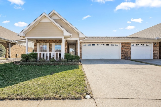 view of front of home with a porch, a garage, brick siding, concrete driveway, and a front lawn