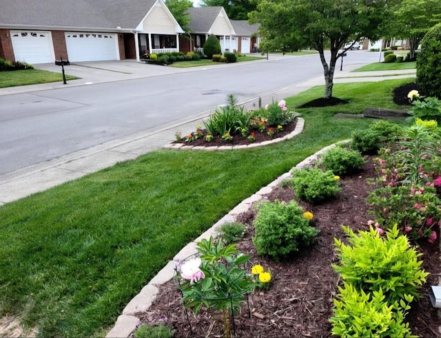 view of yard with a garage and driveway