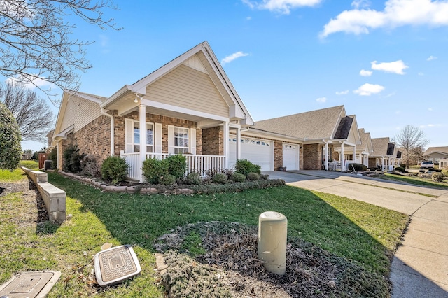 view of front of home with brick siding, covered porch, an attached garage, driveway, and a front lawn