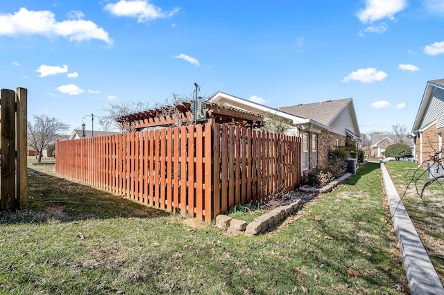 exterior space featuring a yard, brick siding, fence, and a pergola