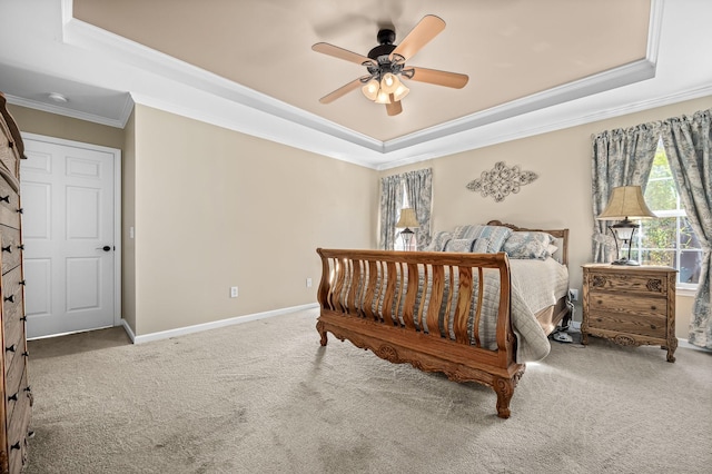 carpeted bedroom featuring ornamental molding, a raised ceiling, ceiling fan, and baseboards