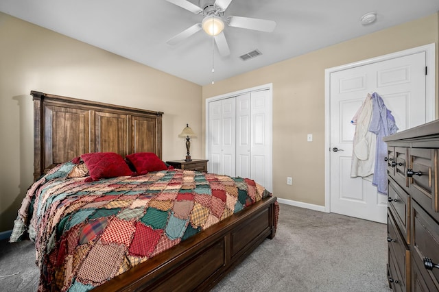 bedroom with a closet, visible vents, a ceiling fan, light carpet, and baseboards