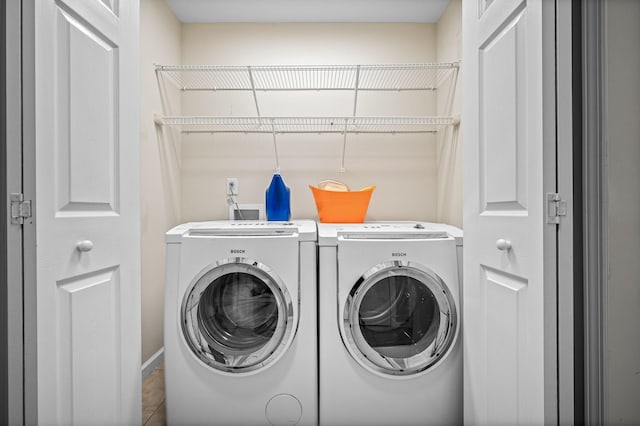 clothes washing area with laundry area and washer and dryer