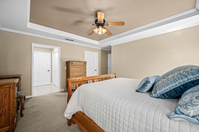 bedroom featuring ornamental molding, carpet, a raised ceiling, and visible vents