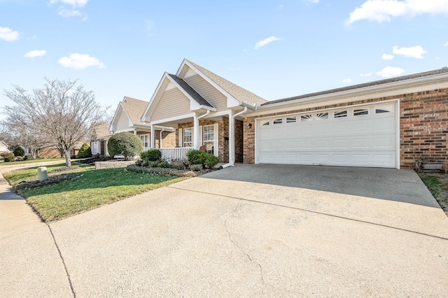 view of front facade featuring a garage, concrete driveway, covered porch, a front lawn, and brick siding