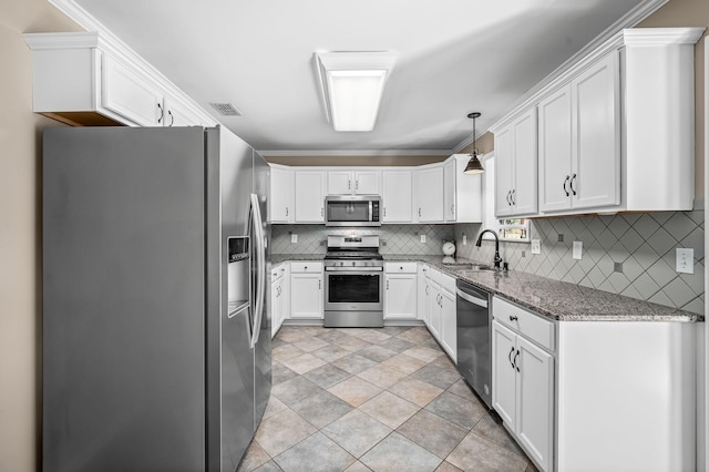 kitchen with stainless steel appliances, visible vents, decorative backsplash, white cabinets, and a sink