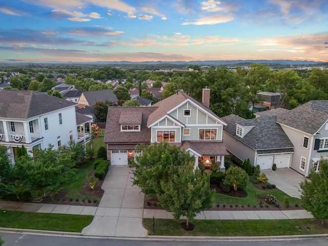 aerial view at dusk featuring a residential view