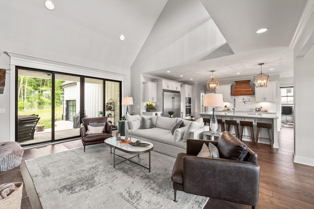 living area with high vaulted ceiling, recessed lighting, dark wood finished floors, and baseboards