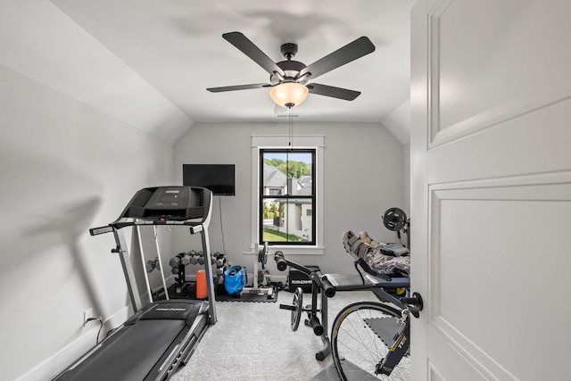 workout room featuring lofted ceiling, carpet, and baseboards