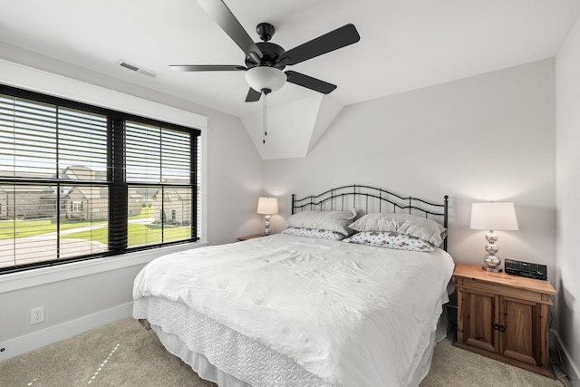 bedroom with lofted ceiling, carpet floors, a ceiling fan, visible vents, and baseboards