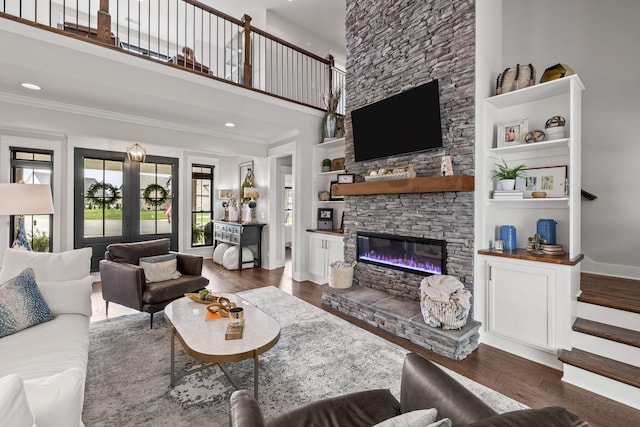 living room featuring stairs, a fireplace, wood finished floors, and french doors