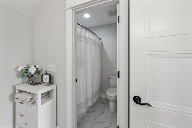 bathroom featuring toilet, marble finish floor, and visible vents