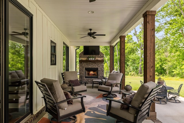 view of patio / terrace featuring ceiling fan and an outdoor stone fireplace