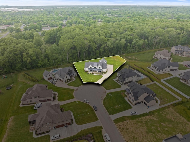 birds eye view of property with a residential view and a view of trees