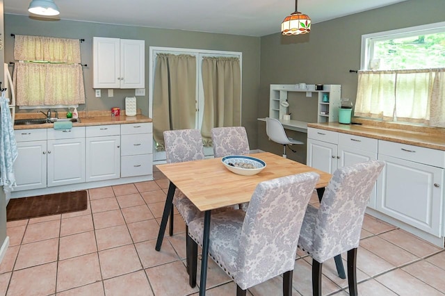 dining area with built in study area and light tile patterned floors