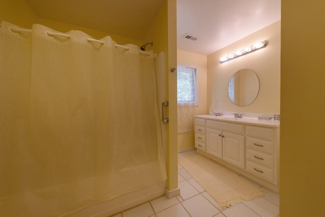 bathroom with curtained shower, tile patterned flooring, visible vents, and vanity