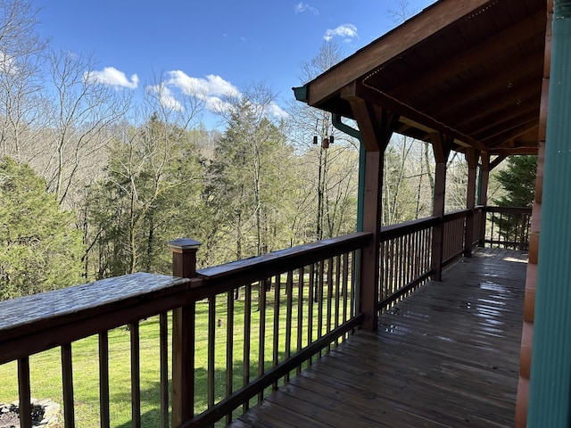 wooden deck featuring a yard