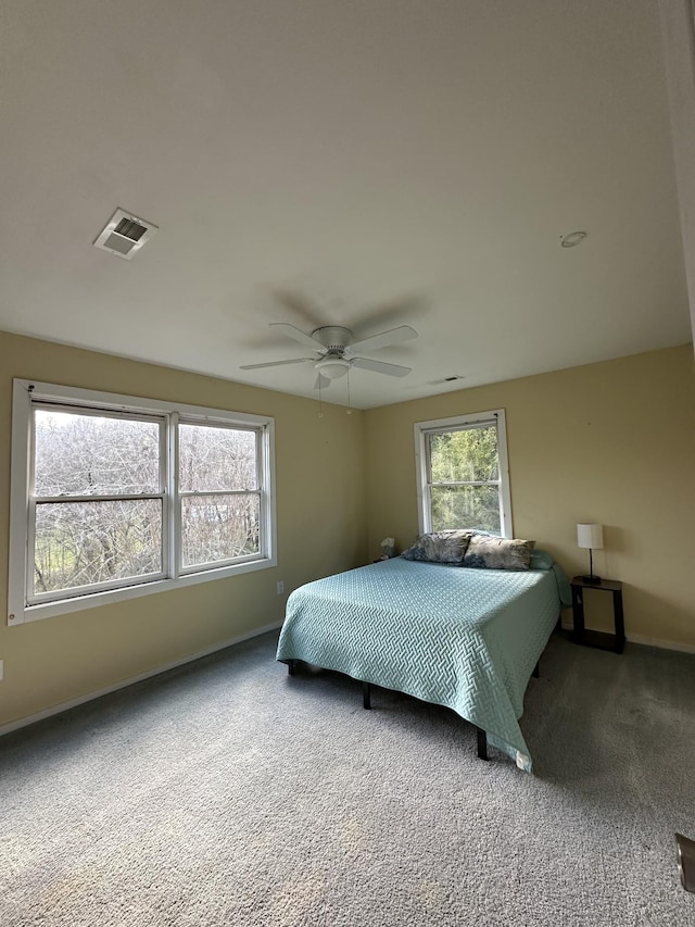 bedroom featuring a ceiling fan, baseboards, visible vents, and carpet flooring