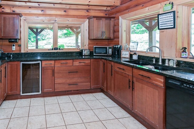 kitchen featuring black dishwasher, stainless steel microwave, brown cabinetry, a sink, and beverage cooler