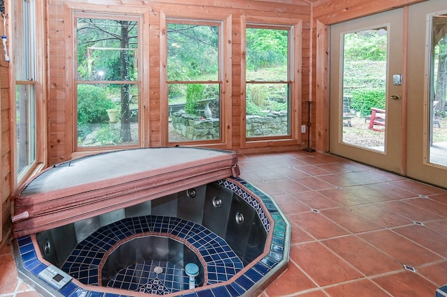 unfurnished sunroom featuring a hot tub