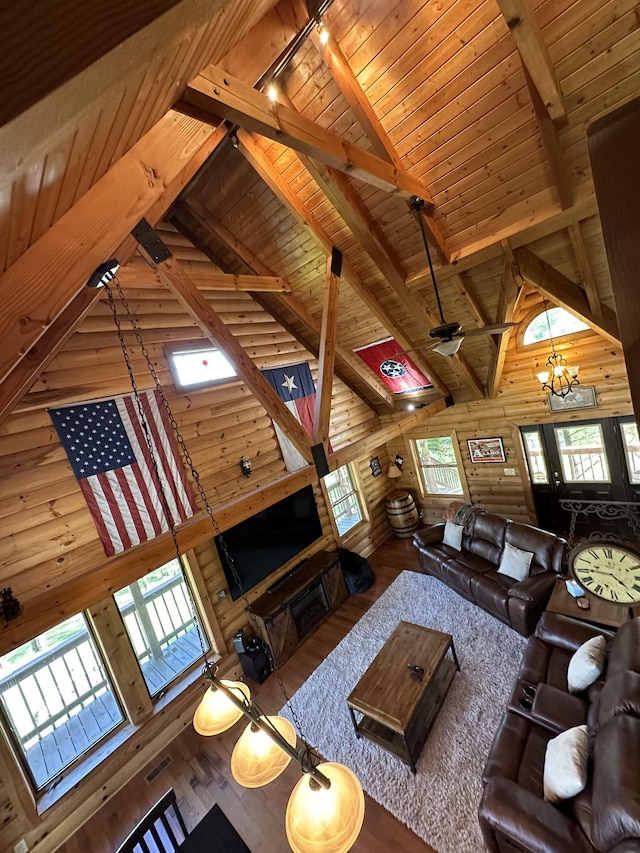 unfurnished living room with beam ceiling, rail lighting, wood finished floors, high vaulted ceiling, and wooden ceiling