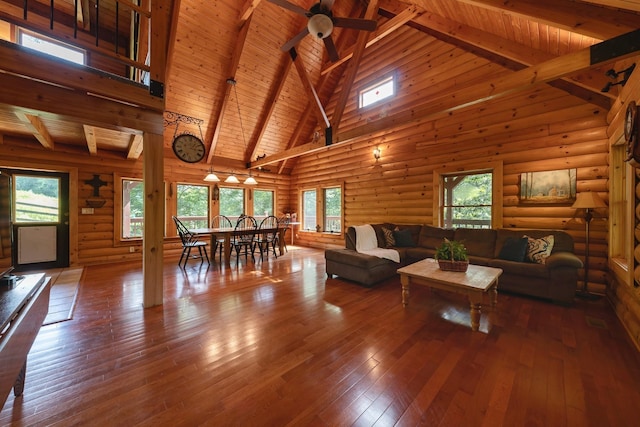 living room with ceiling fan, high vaulted ceiling, wooden ceiling, hardwood / wood-style flooring, and beam ceiling