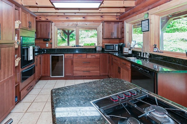 kitchen with light tile patterned floors, wine cooler, black appliances, a sink, and a warming drawer