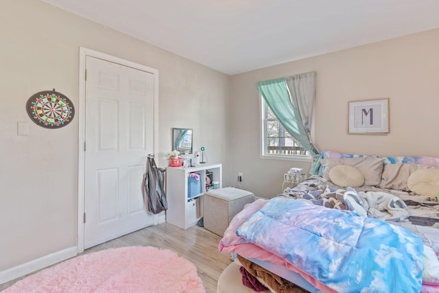 bedroom with baseboards and light wood-style floors