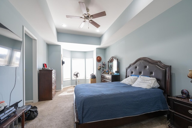 carpeted bedroom with ceiling fan and baseboards