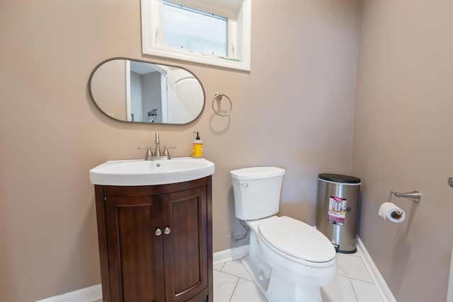 bathroom with marble finish floor, vanity, toilet, and baseboards