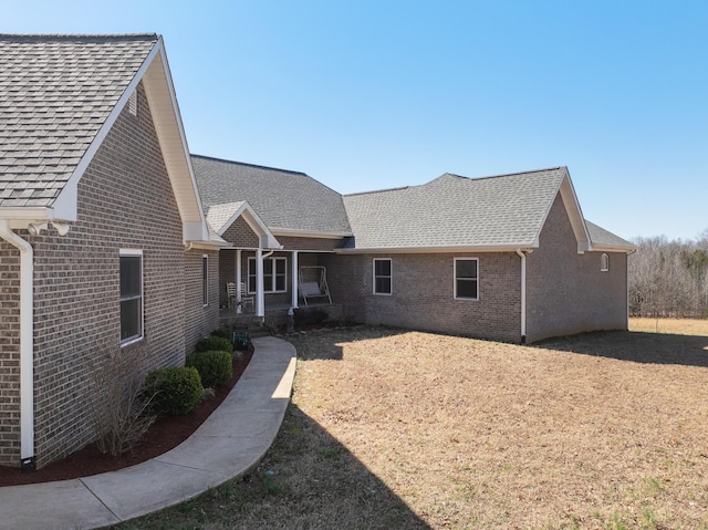 back of property featuring brick siding