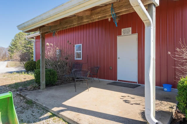 view of exterior entry with a patio